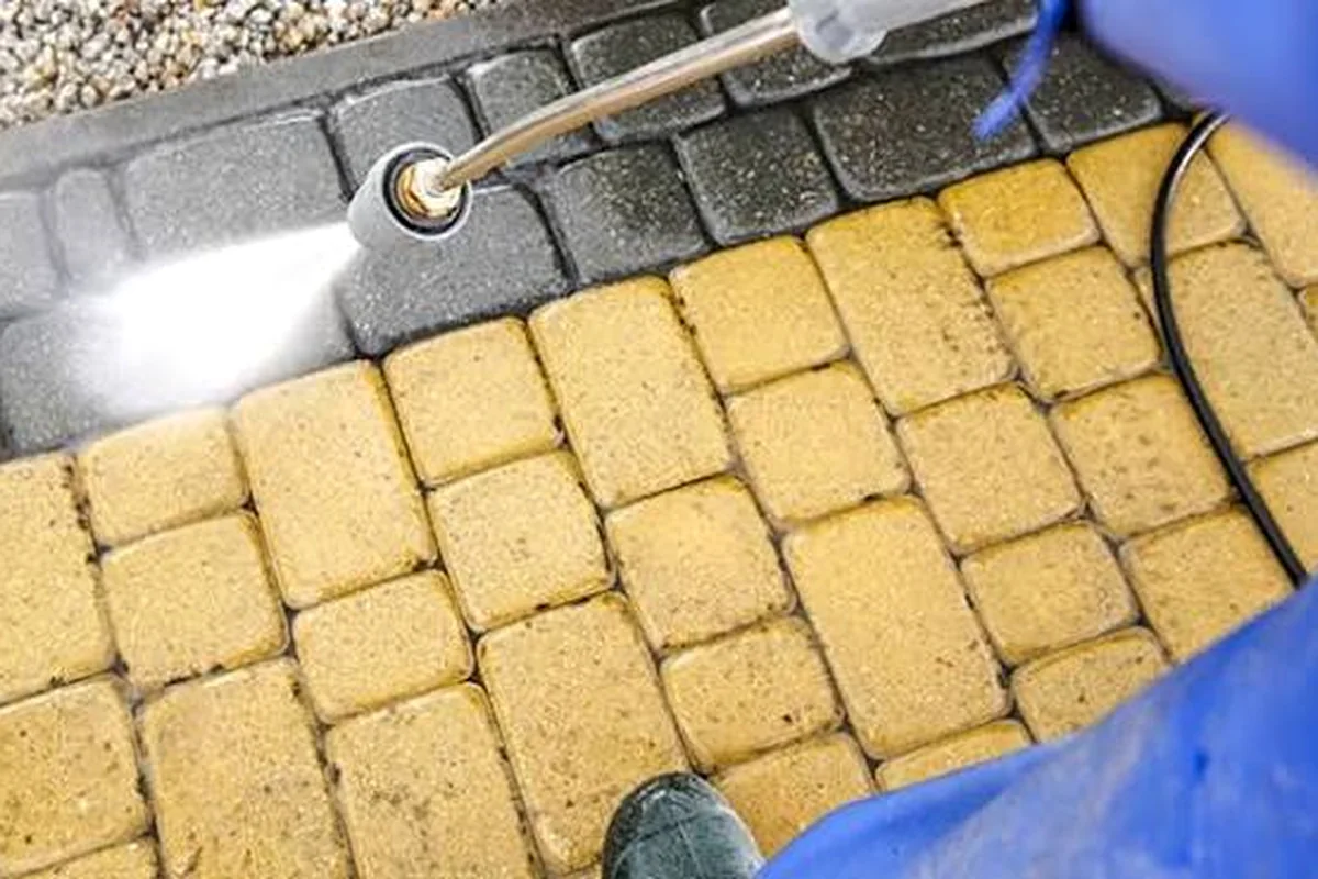 Professional pressure washing cleaning stained pavers